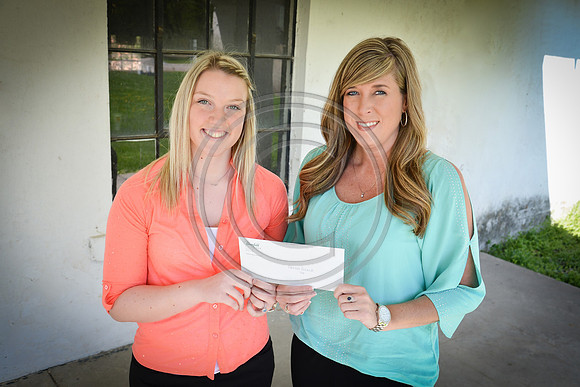 Hannah Rennick receiving a Scholarship Check from HCP Owner Heather Graves